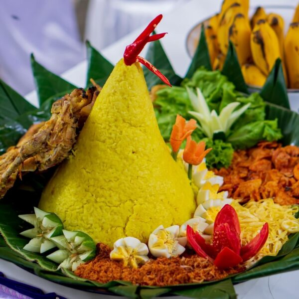 Foto nasi tumpeng khas Rembang yang lezat, disajikan dengan lauk pauk lengkap dan garnish tradisional, siap untuk dinikmati dalam acara spesial.