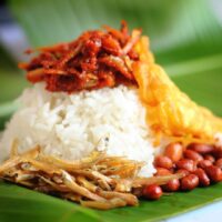 Foto nasi tumpeng khas Tanggungharjo yang lezat, disajikan dengan lauk pauk lengkap dan garnish tradisional, siap untuk dinikmati dalam acara spesial.